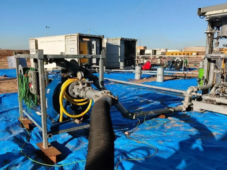 Automatic tank cleaning equipment operating beside an industrial storage tank